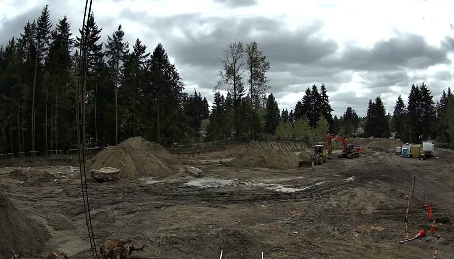 Reolink Go Ultra sample frame showing site excavation with an excavator and dirt piles